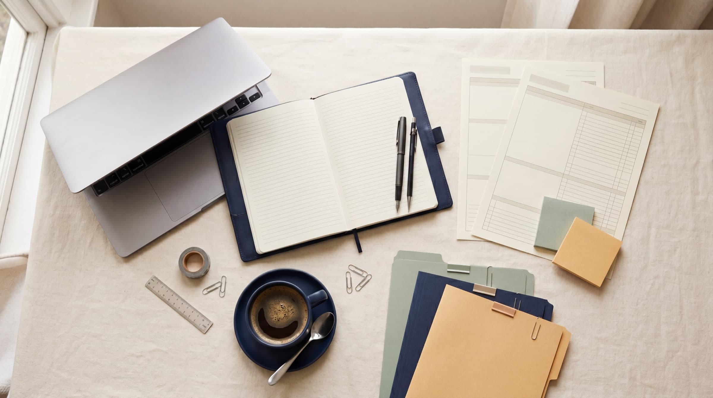 Admissions consulting workspace with laptop, folders, and student planning notes